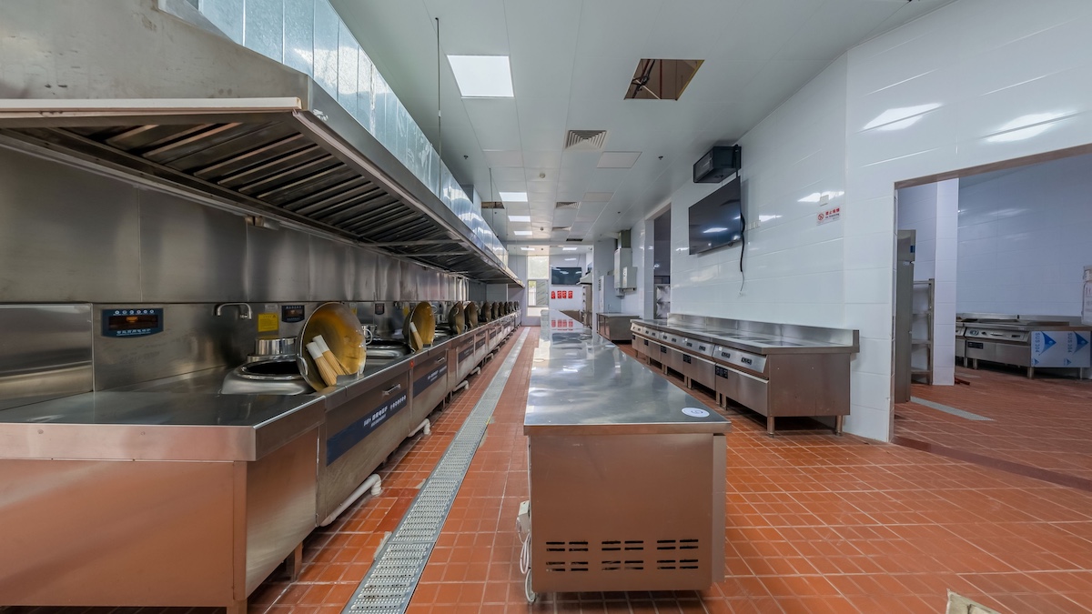 Commercial kitchen floor drain and stainless steel equipment in a restaurant
